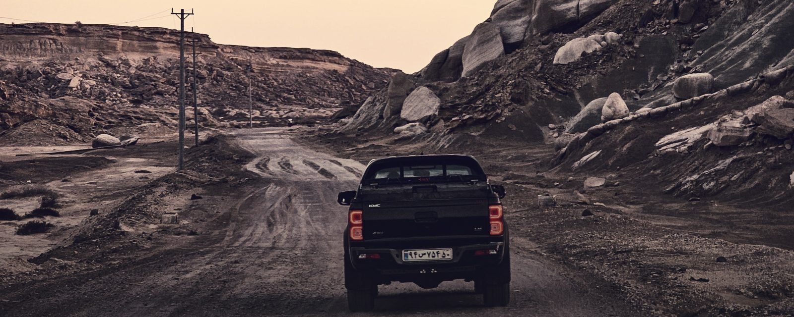 An off-road vehicle on a rough desert track