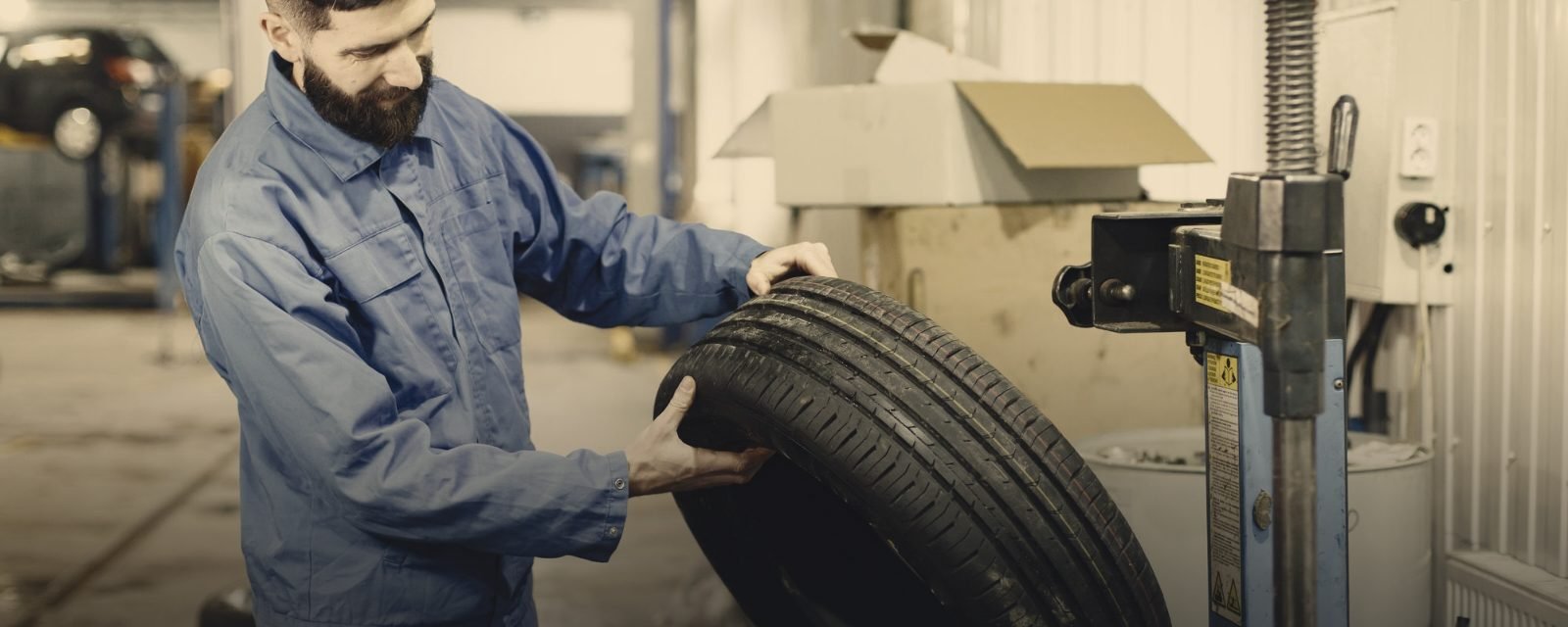 A technician inspecting a tyre in a workshop